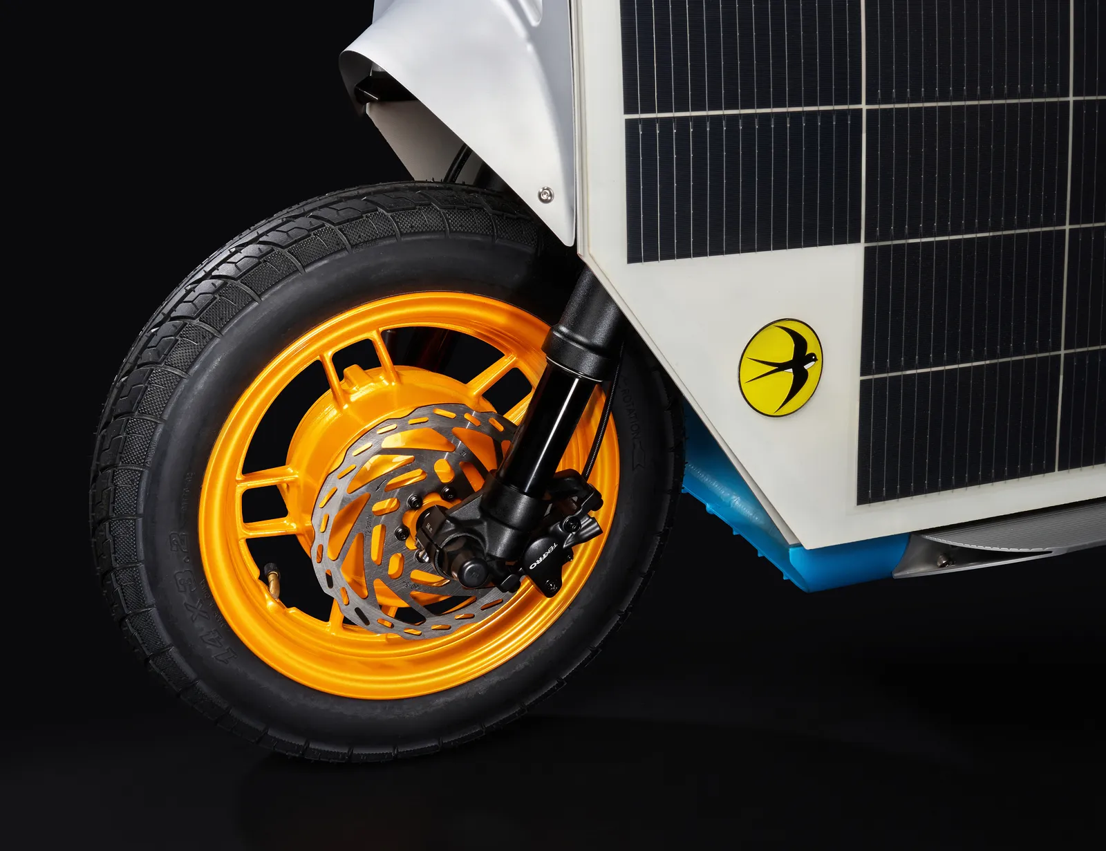 Front fork and orange wheel beneath the solar panel on the nose of the Lightfoot