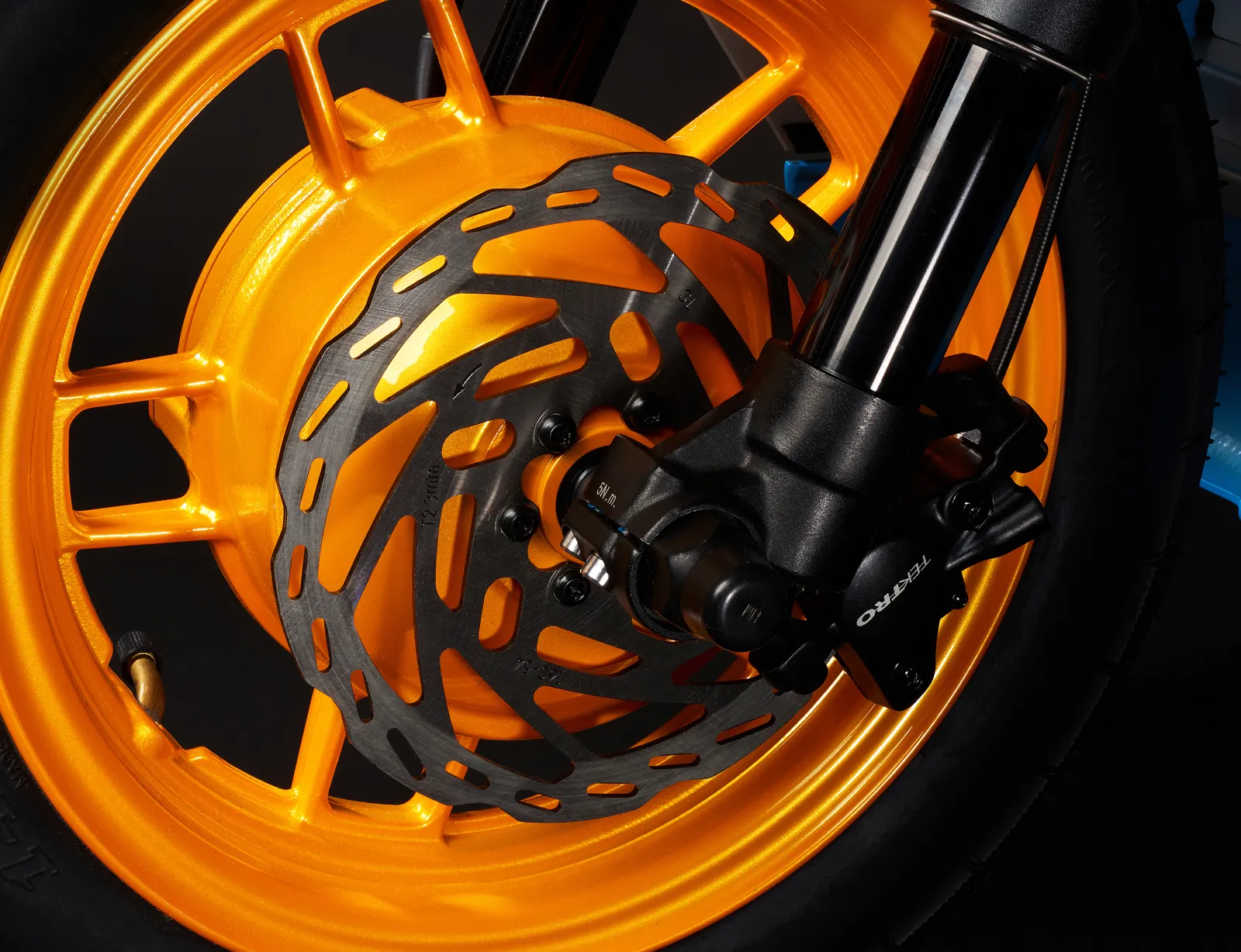 Close-up of the solar orange front wheel with its hub motor and disc brake